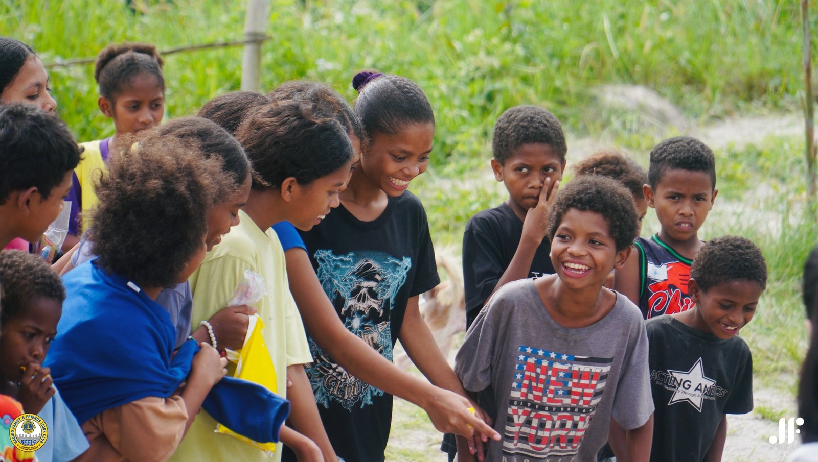 Children receiving goods at a District 301-C community outreach